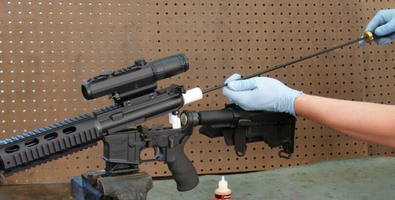 person cleaning an airsoft gun